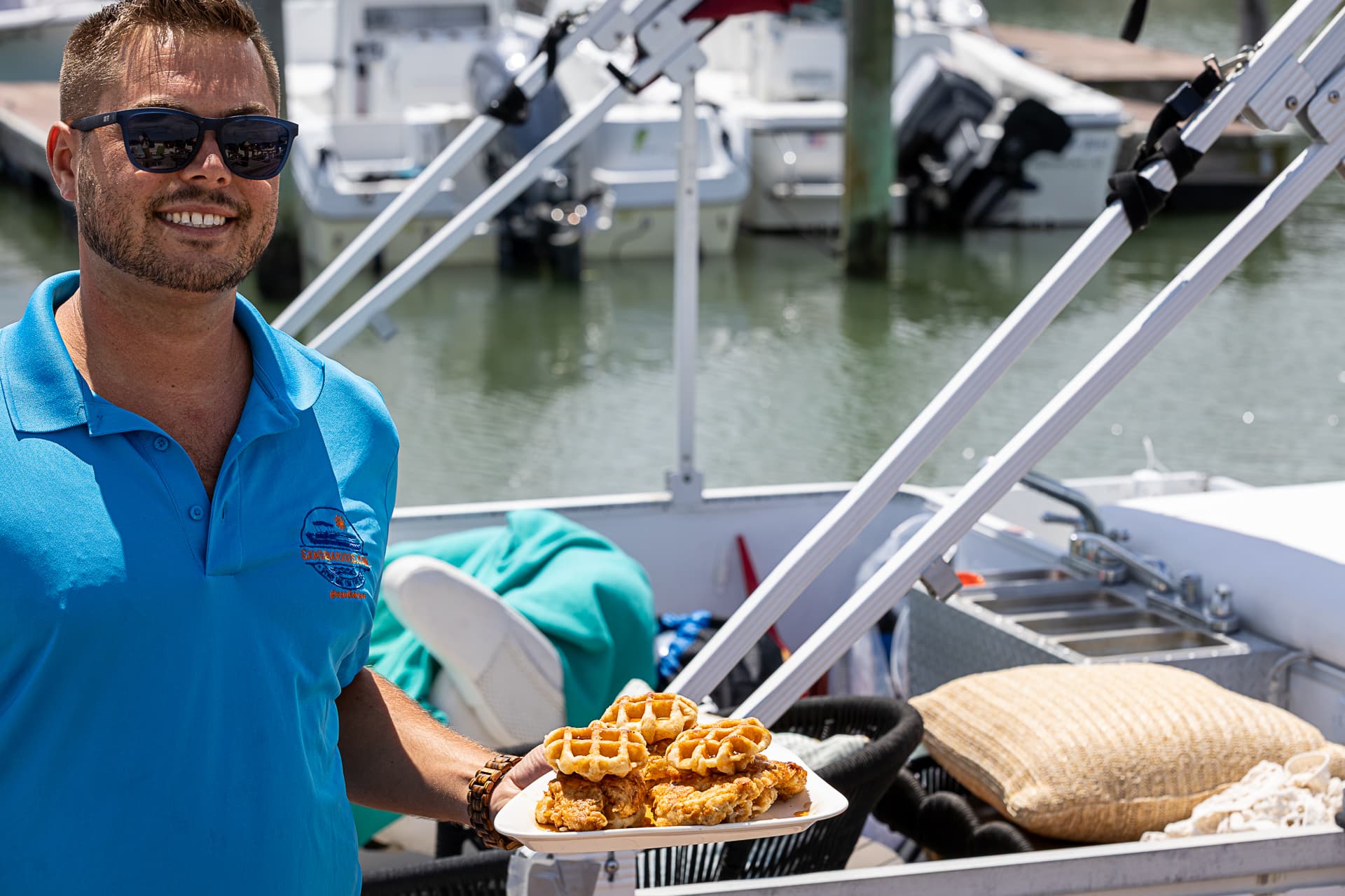 Captain Joe serving chicken and waffles on the Sand Bar Joe's Floating Food Tour in Wildwood NJ