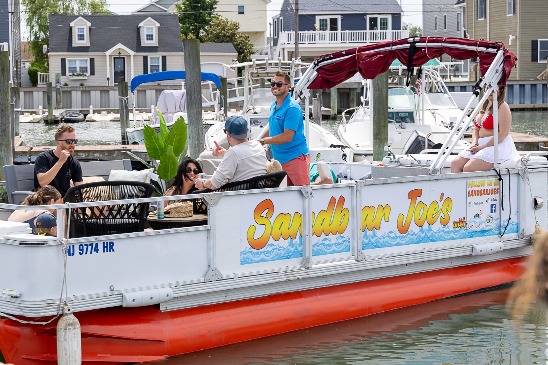 Guests boarding the Sand Bar Joe's pontoon at the Wildwood dock for a private back-bay charter