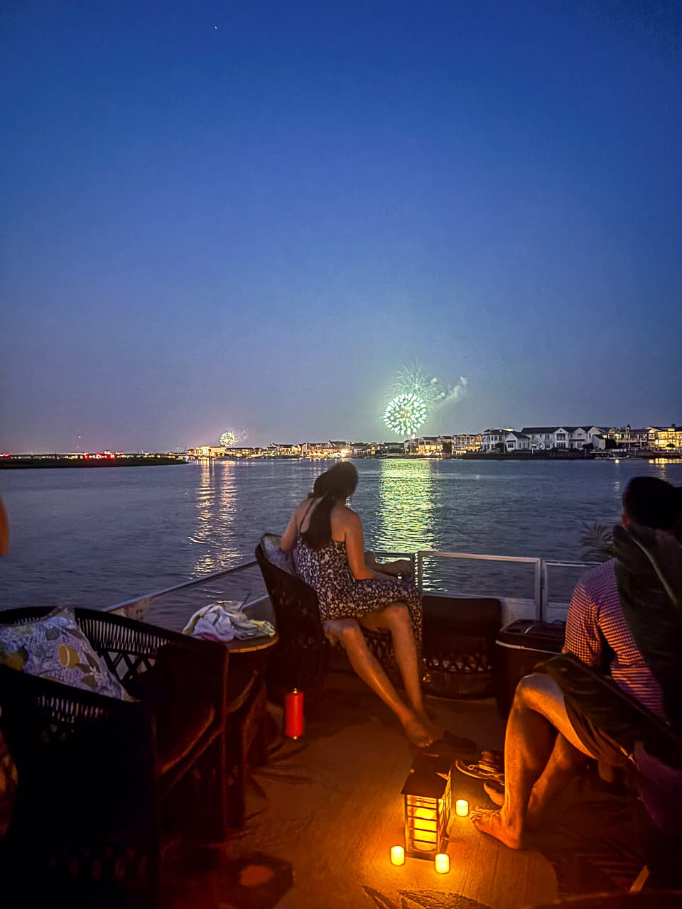 Guests watching the Wildwood fireworks by lantern light on a Sand Bar Joe's evening pontoon cruise